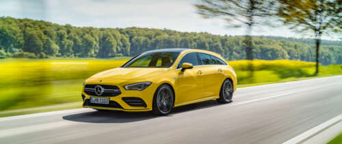 A bright yellow Mercedes-Benz CLA-Class luxury sedan showing its aerodynamic design. UWUHD free hd wallpapers