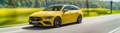 A bright yellow Mercedes-Benz CLA-Class luxury sedan showing its aerodynamic design. Dual UHD free wallpaper for computer
