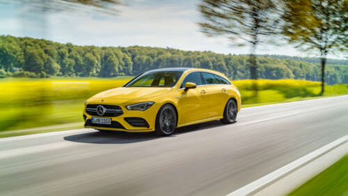 A bright yellow Mercedes-Benz CLA-Class luxury sedan showing its aerodynamic design. 8K hd background