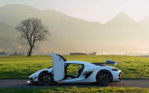 A sleek white Koenigsegg Jesko hypercar showcasing its aerodynamic curves and luxury... wallpaper