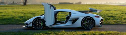 A sleek white Koenigsegg Jesko hypercar showcasing its aerodynamic curves and luxury... Dual UHD high definition wallpaper