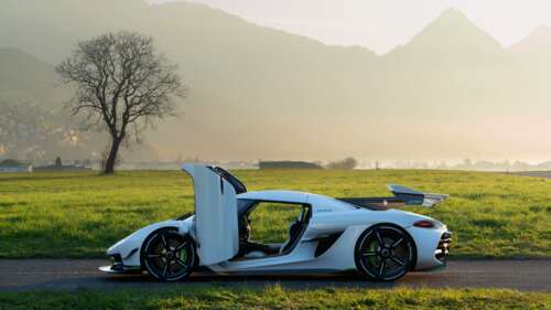 A sleek white Koenigsegg Jesko hypercar showcasing its aerodynamic curves and luxury... 8K free desktop wallpaper