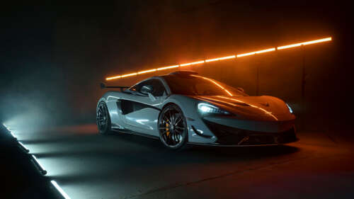 A detailed shot of a white McLaren 620R supercar featuring its modern aerodynamic... 4K (Ultra HD) background images hd