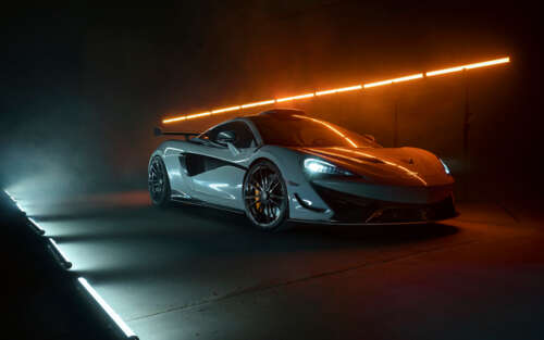 A detailed shot of a white McLaren 620R supercar featuring its modern aerodynamic... free wallpaper