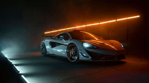 A detailed shot of a white McLaren 620R supercar featuring its modern aerodynamic... 8K wallpaper photo gallery download