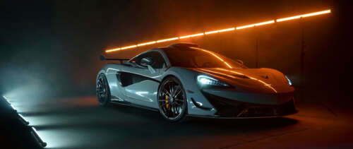 A detailed shot of a white McLaren 620R supercar featuring its modern aerodynamic... UWUHD high definition wallpaper