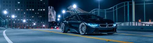 A sleek BMW i8 supercar parked on a dark street at night, featuring glowing headlights... Dual UHD background images hd