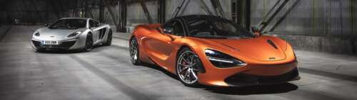 Two McLaren 720S supercars, one in metallic silver and one in bright orange, positioned... Dual UHD