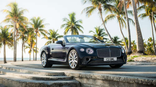 A luxury black Bentley Continental GT convertible showcasing its sleek and polished... 8K free background images
