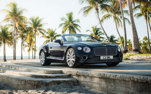 A luxury black Bentley Continental GT convertible showcasing its sleek and polished... 7680x4800 wallpaper photo gallery download