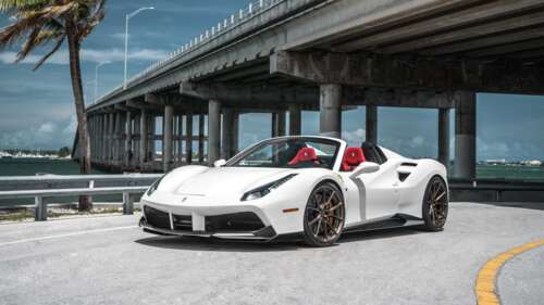 A sleek and polished white Ferrari 488 supercar showcasing its aerodynamic curves... 4K (Ultra HD) wallpaper photo gallery download