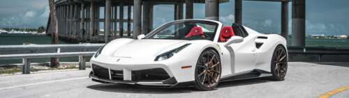 A sleek and polished white Ferrari 488 supercar showcasing its aerodynamic curves... Dual UHD free wallpaper for computer