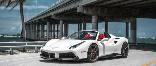 A sleek and polished white Ferrari 488 supercar showcasing its aerodynamic curves... UWUHD