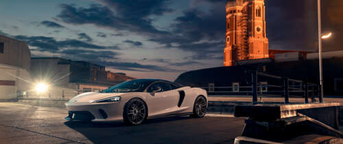 A sleek white McLaren GT supercar featuring modern aerodynamic design and luxury...