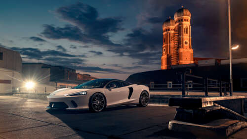 A sleek white McLaren GT supercar featuring modern aerodynamic design and luxury... 8K