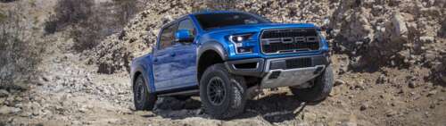 A detailed view of a Ford F-150 Raptor, a high-performance off-road pickup truck. Dual UHD free background