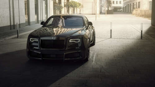 A premium black Rolls-Royce Wraith luxury vehicle featuring a deep glossy finish. wallpaper