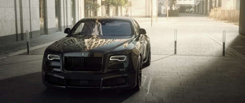 A premium black Rolls-Royce Wraith luxury vehicle featuring a deep glossy finish.