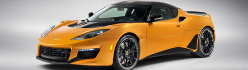 A vibrant orange Lotus Evora GT supercar featuring sleek aerodynamic curves. Dual UHD