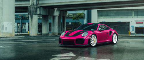 A bright pink Porsche 911 GT2 RS luxury sports car UWUHD free desktop wallpaper