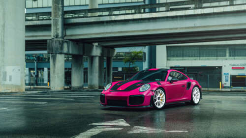 A bright pink Porsche 911 GT2 RS luxury sports car