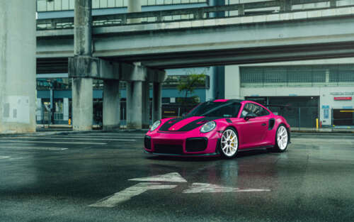 A bright pink Porsche 911 GT2 RS luxury sports car