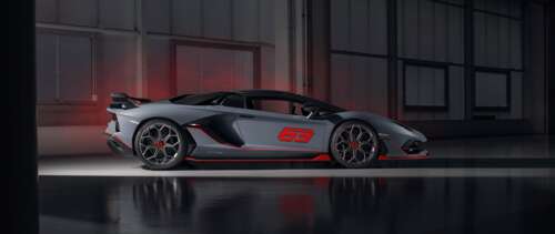 A sleek, metallic silver Lamborghini Aventador SVJ supercar showcasing its aerodynamic... UWUHD free wallpaper