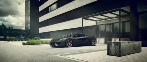 A glossy black McLaren 570S supercar showcasing its sleek aerodynamic design. UWUHD free wallpaper for computer