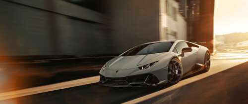 A sleek silver Lamborghini Huracan Evo supercar showcasing its aerodynamic design... UWUHD wallpaper download