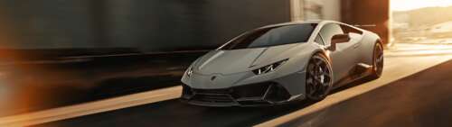 A sleek silver Lamborghini Huracan Evo supercar showcasing its aerodynamic design... Dual UHD free desktop wallpaper