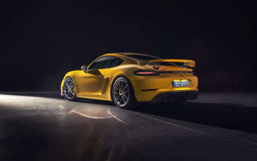 A vibrant yellow Porsche 718 Cayman sports car. 7680x4800 hd background