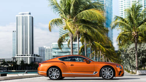 A sleek orange Bentley Continental GT luxury car. 4K (Ultra HD) high definition wallpaper