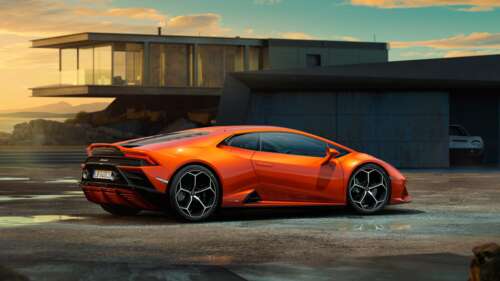 A sleek and powerful orange Lamborghini Huracan Evo supercar featuring aerodynamic... 8K high definition wallpaper