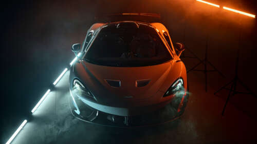 A high-performance McLaren 620R supercar in a bright orange finish, showcasing its... 8K ps4 wallpaper