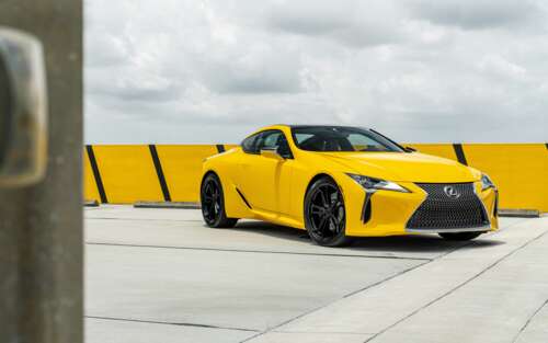 A sleek and vibrant yellow Lexus LC 500 supercar featuring aerodynamic luxury styling. wallpaper