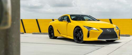 A sleek and vibrant yellow Lexus LC 500 supercar featuring aerodynamic luxury styling. UWUHD free background images