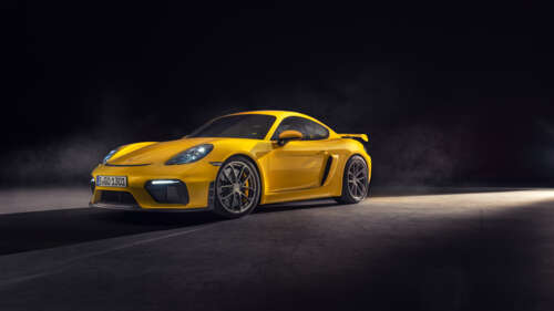 A high-gloss yellow Porsche 718 Cayman sports car featuring sleek aerodynamic lines. 4K (Ultra HD)