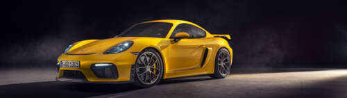 A high-gloss yellow Porsche 718 Cayman sports car featuring sleek aerodynamic lines. Dual UHD pictures for wallpaper