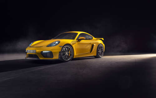 A high-gloss yellow Porsche 718 Cayman sports car featuring sleek aerodynamic lines. 7680x4800 pictures for wallpaper