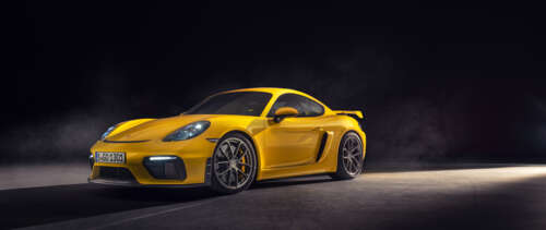 A high-gloss yellow Porsche 718 Cayman sports car featuring sleek aerodynamic lines. UWUHD hd background