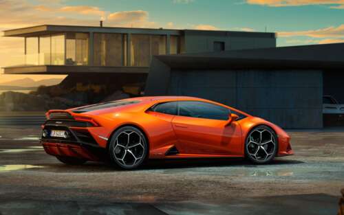 A sleek and powerful orange Lamborghini Huracan Evo supercar featuring aerodynamic... 7680x4800 high definition wallpaper