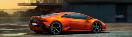 A sleek and powerful orange Lamborghini Huracan Evo supercar featuring aerodynamic... Dual UHD high definition wallpaper