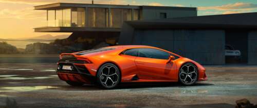 A sleek and powerful orange Lamborghini Huracan Evo supercar featuring aerodynamic... UWUHD background images hd