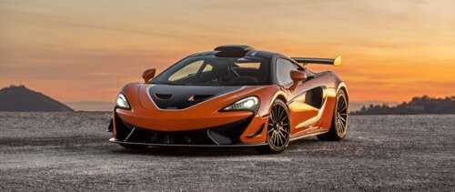 A high-performance McLaren 620R supercar in a striking vibrant orange color. UWUHD free hd wallpapers