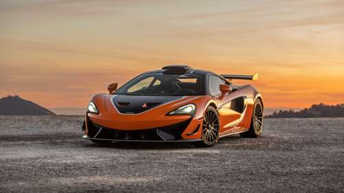 A high-performance McLaren 620R supercar in a striking vibrant orange color. 8K free wallpaper