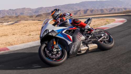 A 2024 BMW M 1000 RR motorcycle speeding along a professional racing circuit. free wallpaper for computer