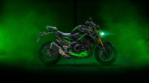 A high-resolution shot of a green 2024 Kawasaki Z900 sports motorcycle. free desktop wallpaper