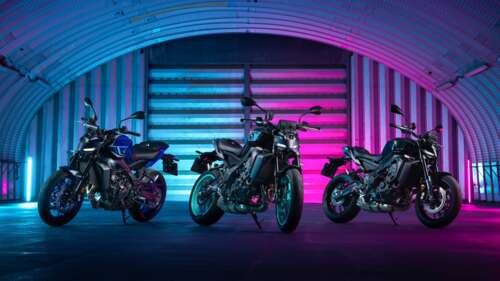 A 2024 Yamaha MT-09 naked motorcycle glowing with neon lights in a dark city setting. wallpaper
