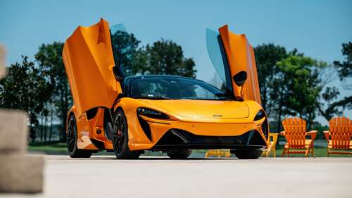 A sleek and aerodynamic 2025 McLaren Artura Spider sports car displayed in high definition. wallpaper