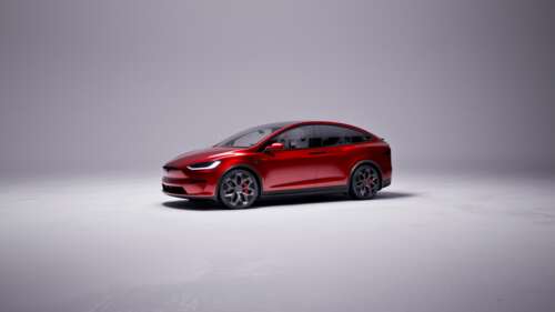 A high-performance 2025 Tesla Model X Plaid electric SUV in a striking red finish. wallpaper